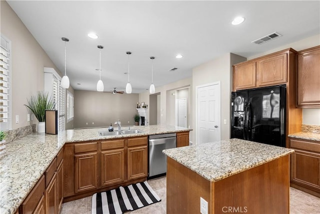 kitchen featuring dishwasher, sink, hanging light fixtures, black fridge, and kitchen peninsula