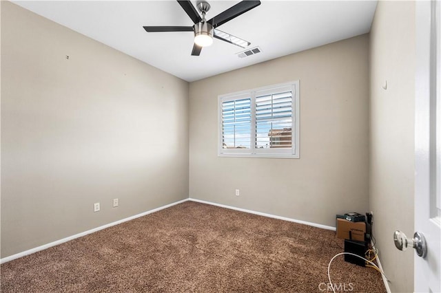 empty room featuring ceiling fan and carpet