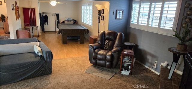 living room featuring ceiling fan, pool table, and hardwood / wood-style floors