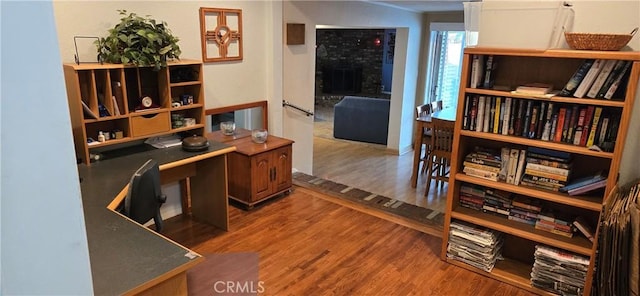 office area with a fireplace and hardwood / wood-style flooring