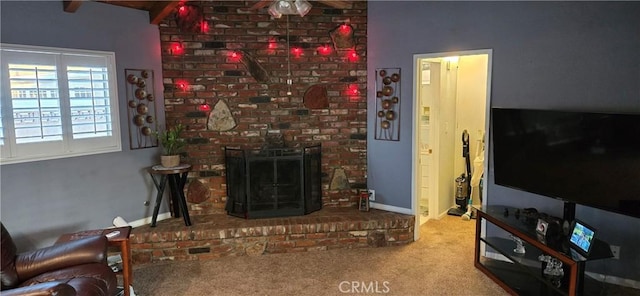 carpeted living room featuring a brick fireplace and beamed ceiling