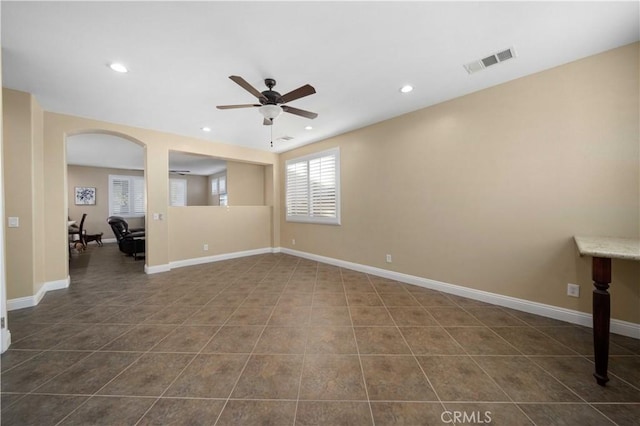 tiled empty room with ceiling fan