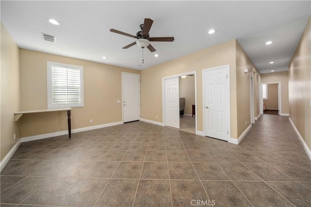 unfurnished room with ceiling fan and tile patterned floors