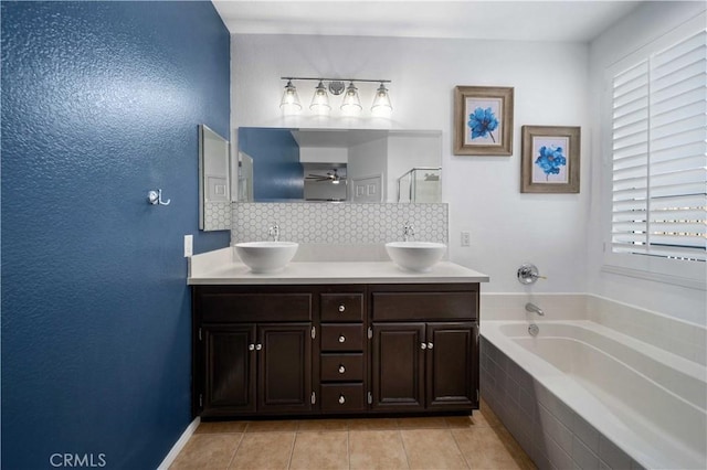 bathroom featuring plenty of natural light, tile patterned floors, tasteful backsplash, and vanity