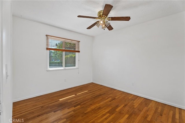 spare room featuring ceiling fan and wood-type flooring