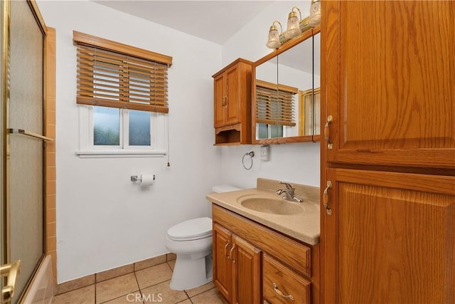 full bathroom with toilet, bath / shower combo with glass door, tile patterned floors, and vanity