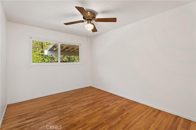 spare room featuring ceiling fan and wood-type flooring