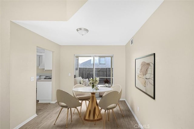 dining space featuring hardwood / wood-style floors