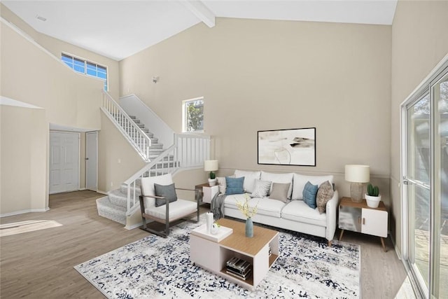 living room featuring beam ceiling, high vaulted ceiling, and hardwood / wood-style floors