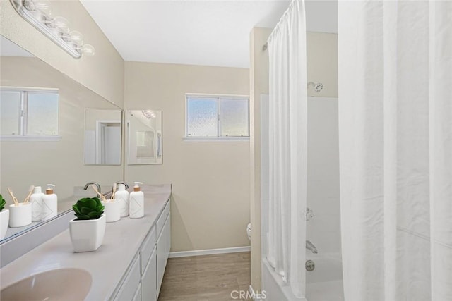 full bathroom with toilet, vanity, wood-type flooring, and shower / bathtub combination with curtain