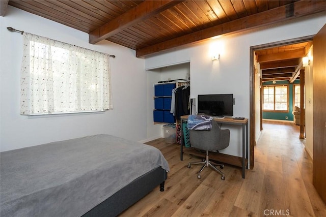 bedroom with a closet, wood-type flooring, wooden ceiling, and beamed ceiling