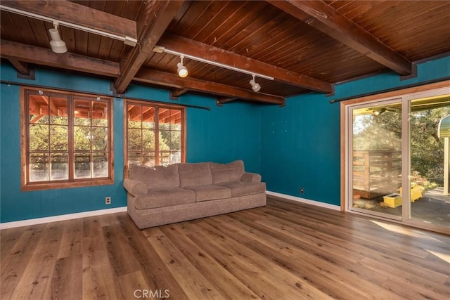 unfurnished living room with wooden ceiling, wood-type flooring, track lighting, and beamed ceiling