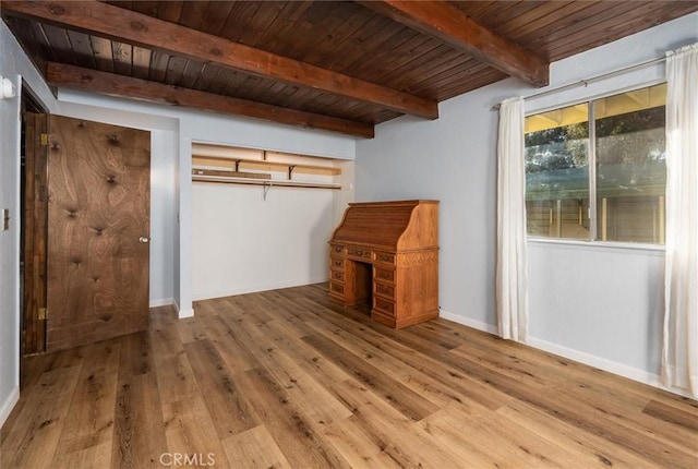 unfurnished bedroom featuring wooden ceiling, wood-type flooring, and beamed ceiling