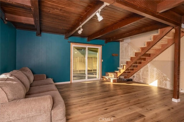 unfurnished living room with wood ceiling, rail lighting, wood-type flooring, and beamed ceiling