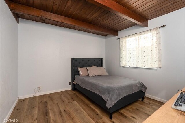 bedroom featuring wood ceiling, beam ceiling, and light hardwood / wood-style flooring