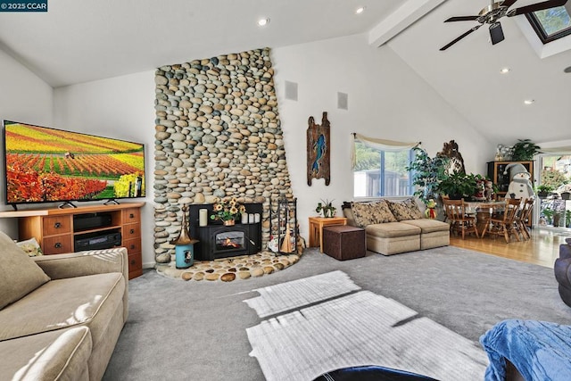 living room featuring carpet, a fireplace, high vaulted ceiling, ceiling fan, and beam ceiling