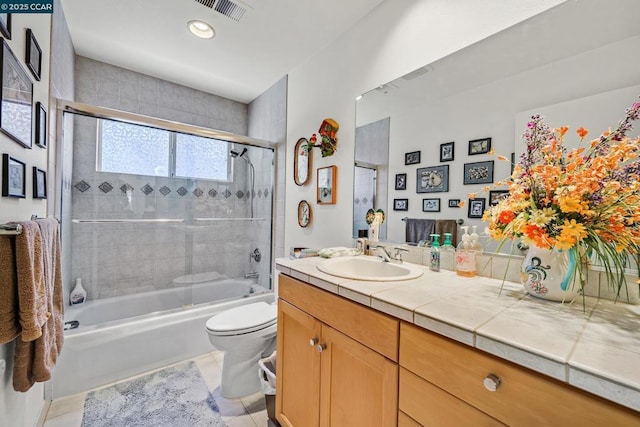 full bathroom with toilet, enclosed tub / shower combo, vanity, and tile patterned floors