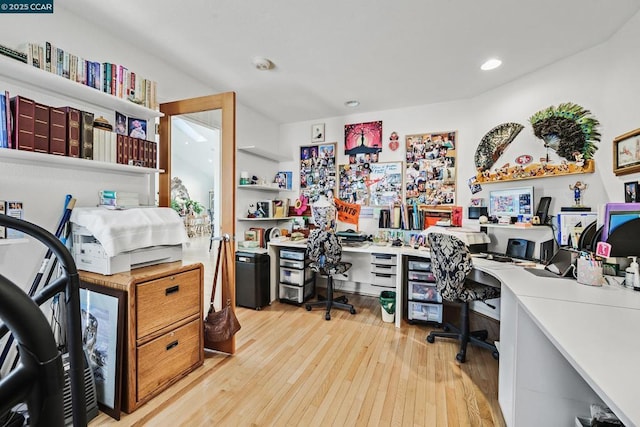 office with light hardwood / wood-style flooring and built in desk