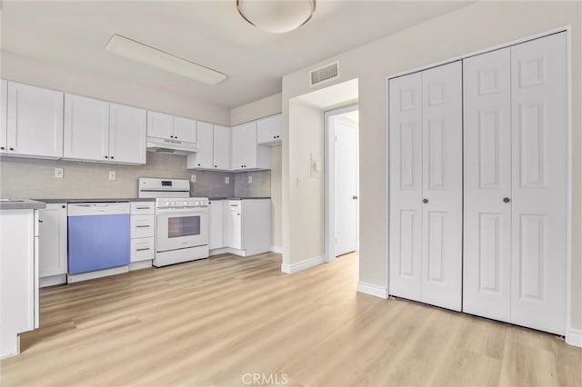 kitchen with white cabinets, dishwasher, tasteful backsplash, light hardwood / wood-style flooring, and white range