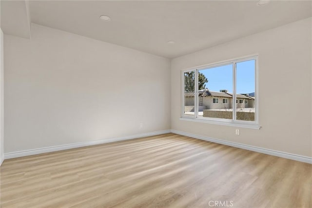 unfurnished room with light hardwood / wood-style floors