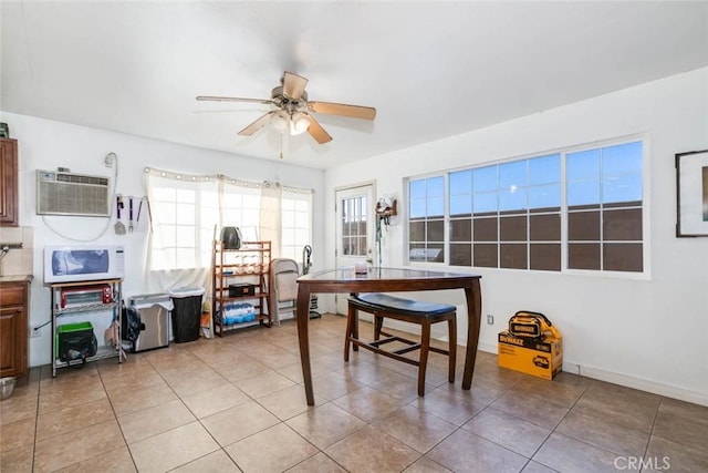 office space featuring a wall unit AC, ceiling fan, and light tile patterned floors