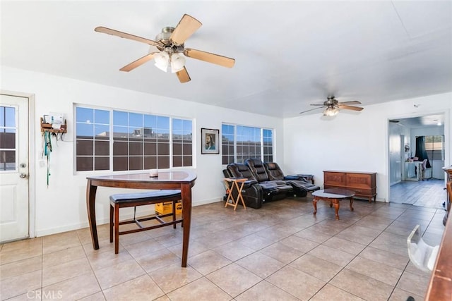 living room with ceiling fan and light tile patterned floors