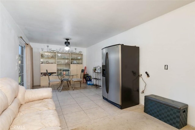 living room featuring ceiling fan and light tile patterned floors