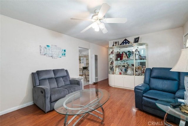 living room with ceiling fan and wood-type flooring