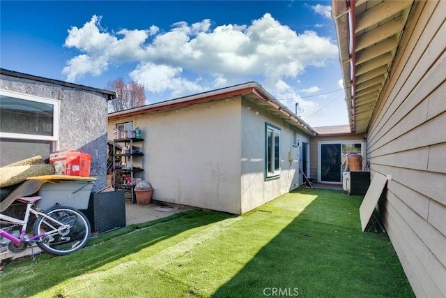 view of side of home featuring a lawn