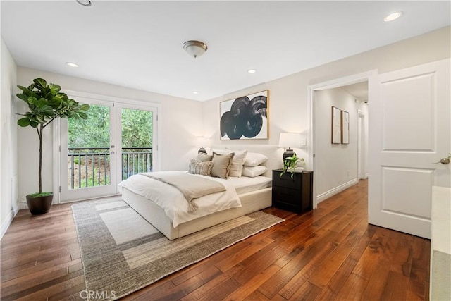 bedroom with dark hardwood / wood-style flooring and access to outside