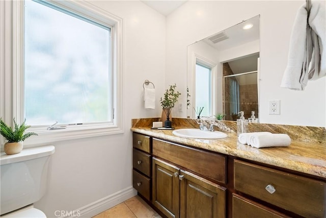 bathroom featuring a shower, toilet, vanity, and tile patterned flooring