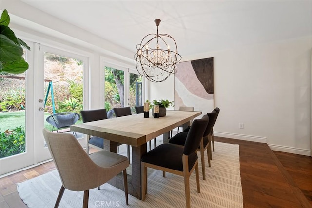 dining room featuring hardwood / wood-style flooring and an inviting chandelier