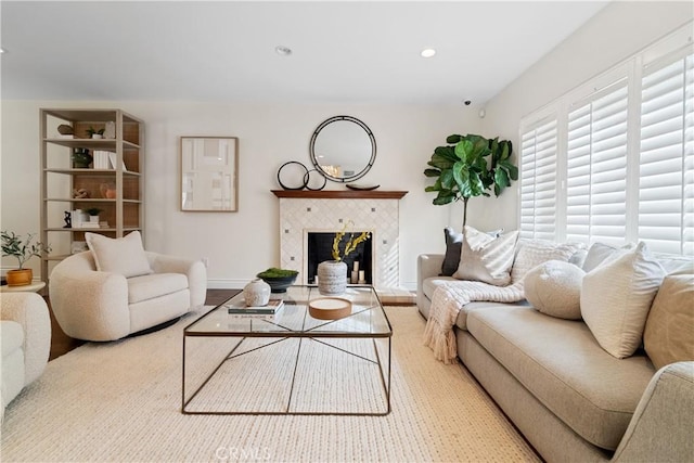 living room with a tiled fireplace