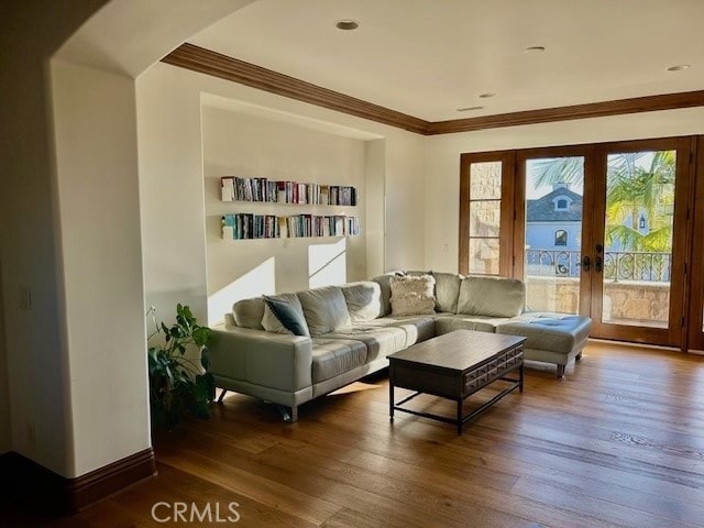 sitting room with hardwood / wood-style floors, ornamental molding, and french doors