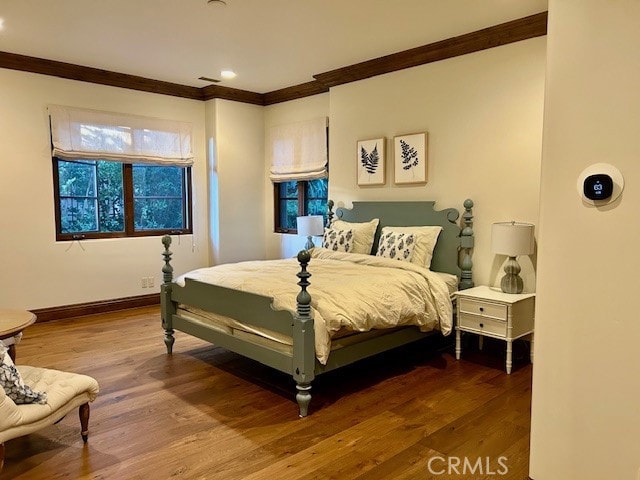 bedroom featuring hardwood / wood-style floors and ornamental molding