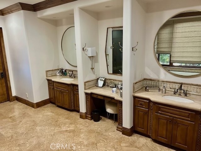 bathroom with crown molding and vanity