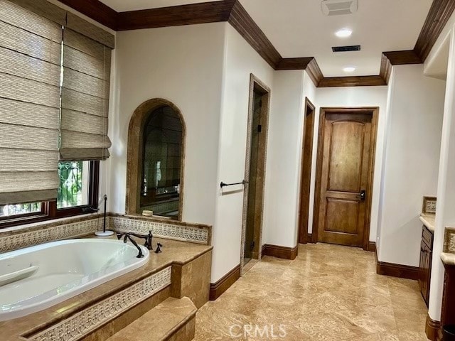 bathroom featuring vanity, a relaxing tiled tub, and ornamental molding