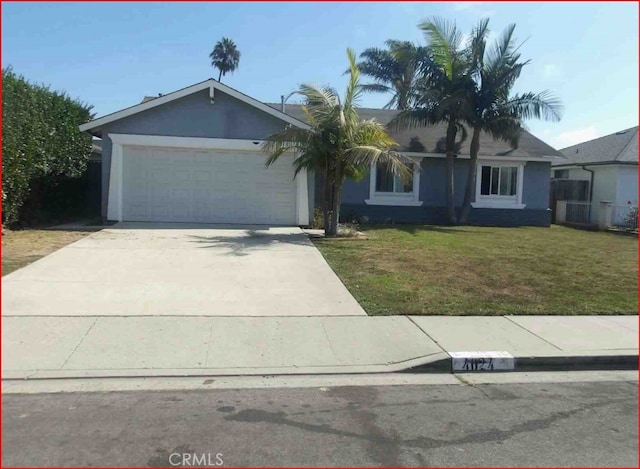 view of front of home featuring a garage and a front yard