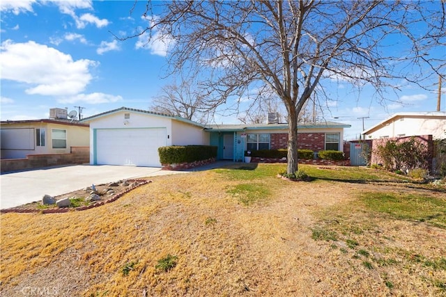 single story home with a front yard and a garage