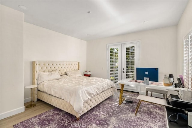 bedroom featuring french doors, access to exterior, and wood-type flooring