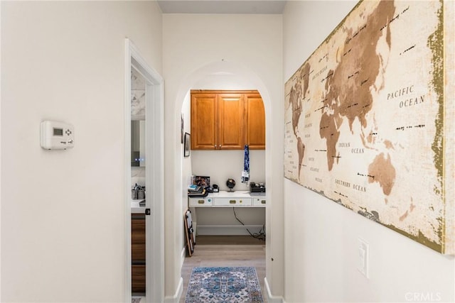 corridor with hardwood / wood-style flooring