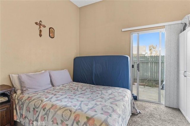 bedroom featuring light carpet and access to outside