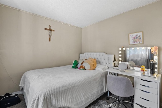 bedroom with a textured ceiling and carpet floors