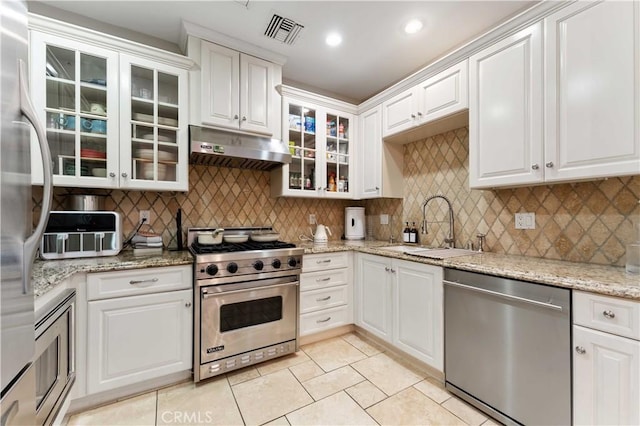 kitchen featuring sink, white cabinets, stainless steel appliances, and tasteful backsplash