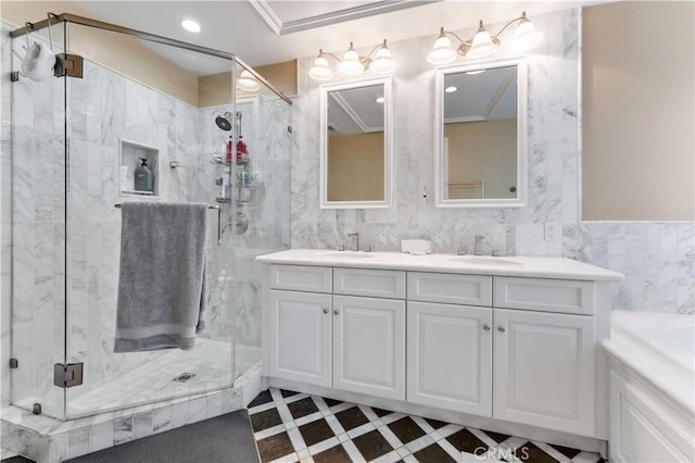 bathroom with tile walls, an enclosed shower, vanity, and crown molding