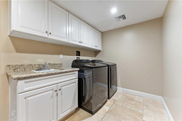 laundry room featuring cabinets, washer and dryer, and sink