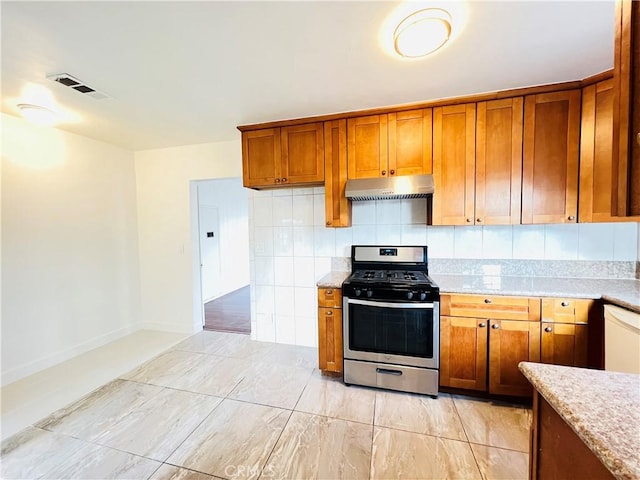 kitchen with tasteful backsplash, dishwasher, stainless steel range with gas stovetop, and light stone counters