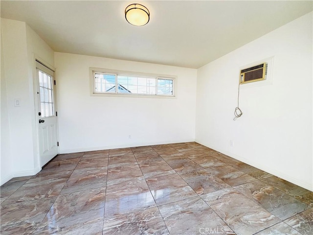 spare room with a wall mounted air conditioner