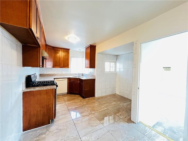 kitchen with dishwasher, extractor fan, sink, tile walls, and black range with gas stovetop