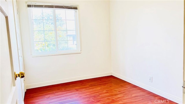 empty room with hardwood / wood-style floors